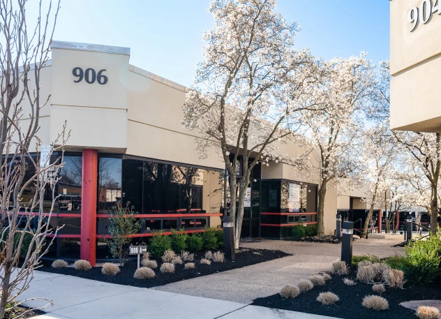 The front entrance of MG Dental Associates at 906 Oak Tree Avenue in South Plainfield, with flowering trees